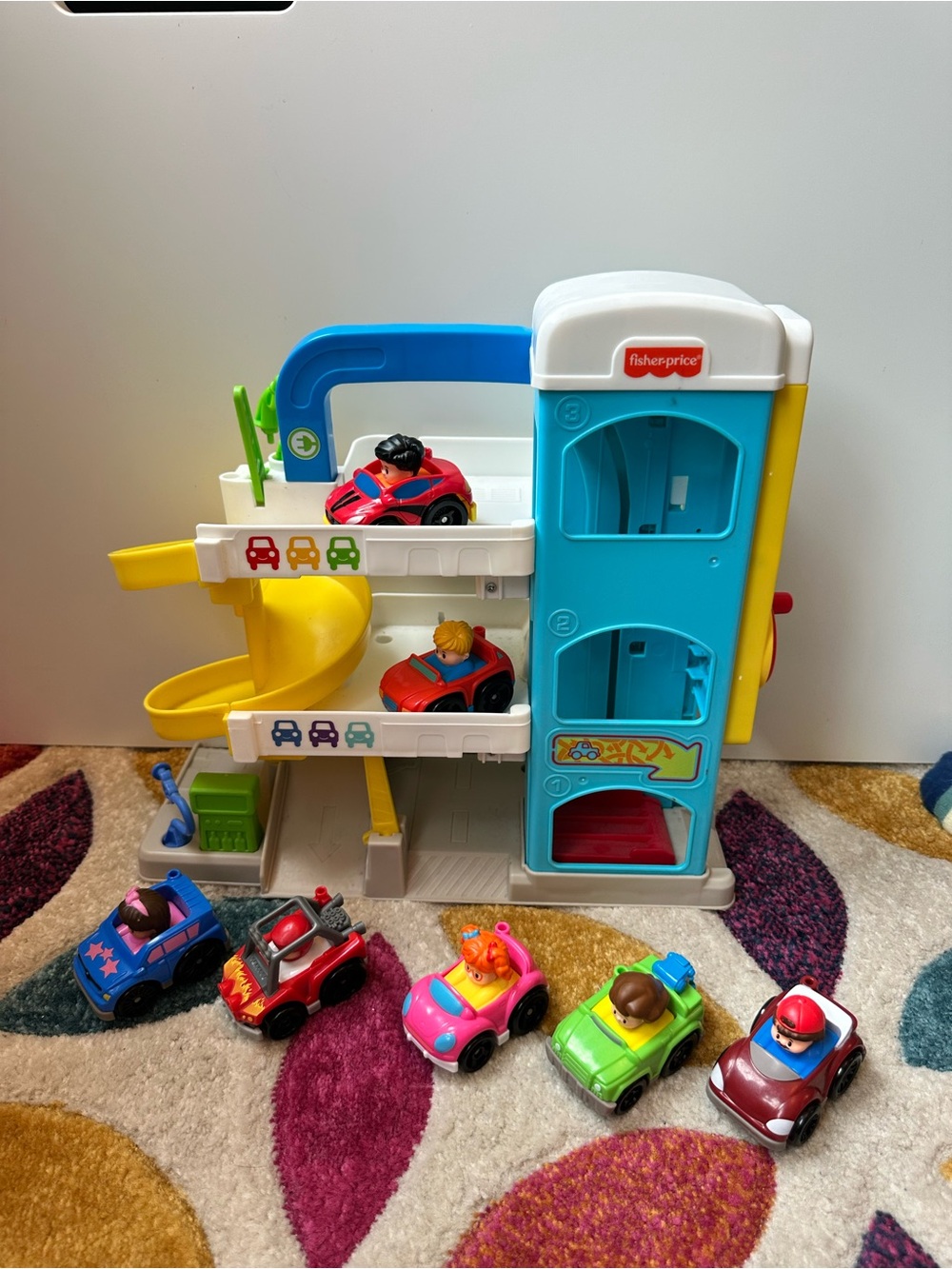 Fisher-Price Helpful Neighborhood Parking Garage Playset with 7 Cars